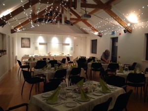 Tables laid for a dinner under fairy lights