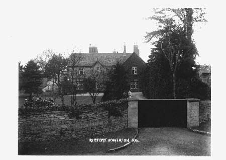 The Old Rectory behind a stone wall and gate, on an old postcard